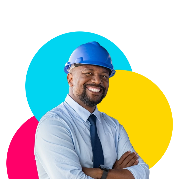A man in a hard hat, dress shirt, and tie that was placed by a manufacturing staffing agency.